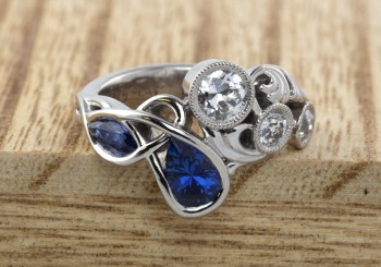 Mixed style engagement ring with Yogo Sapphires and Diamonds.