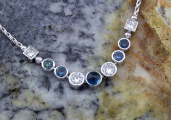 A twist on a graduated stone necklace with Montana Sapphires and Diamonds.