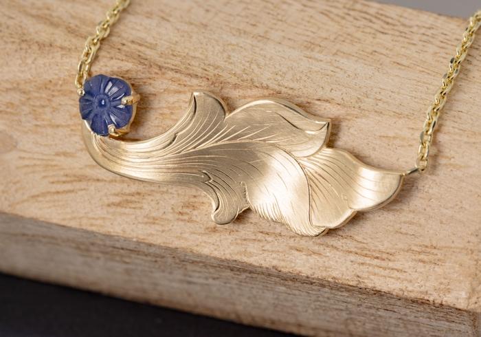 Carved Yogo Sapphire in a Hand Engraved Pendant